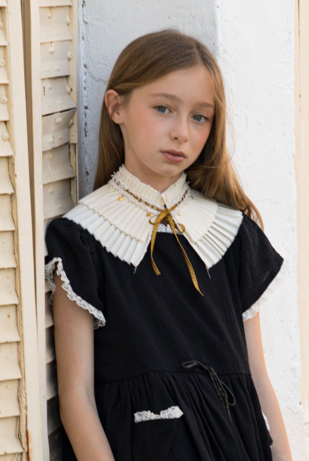 pleated collar with gold bow and stars detail