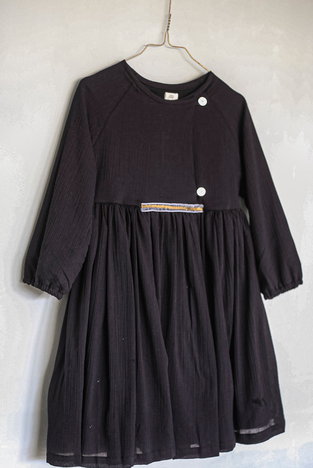 Modest dress in black. Long sleeve. Crossed chest. Velvet and gold detail. European brand dresses