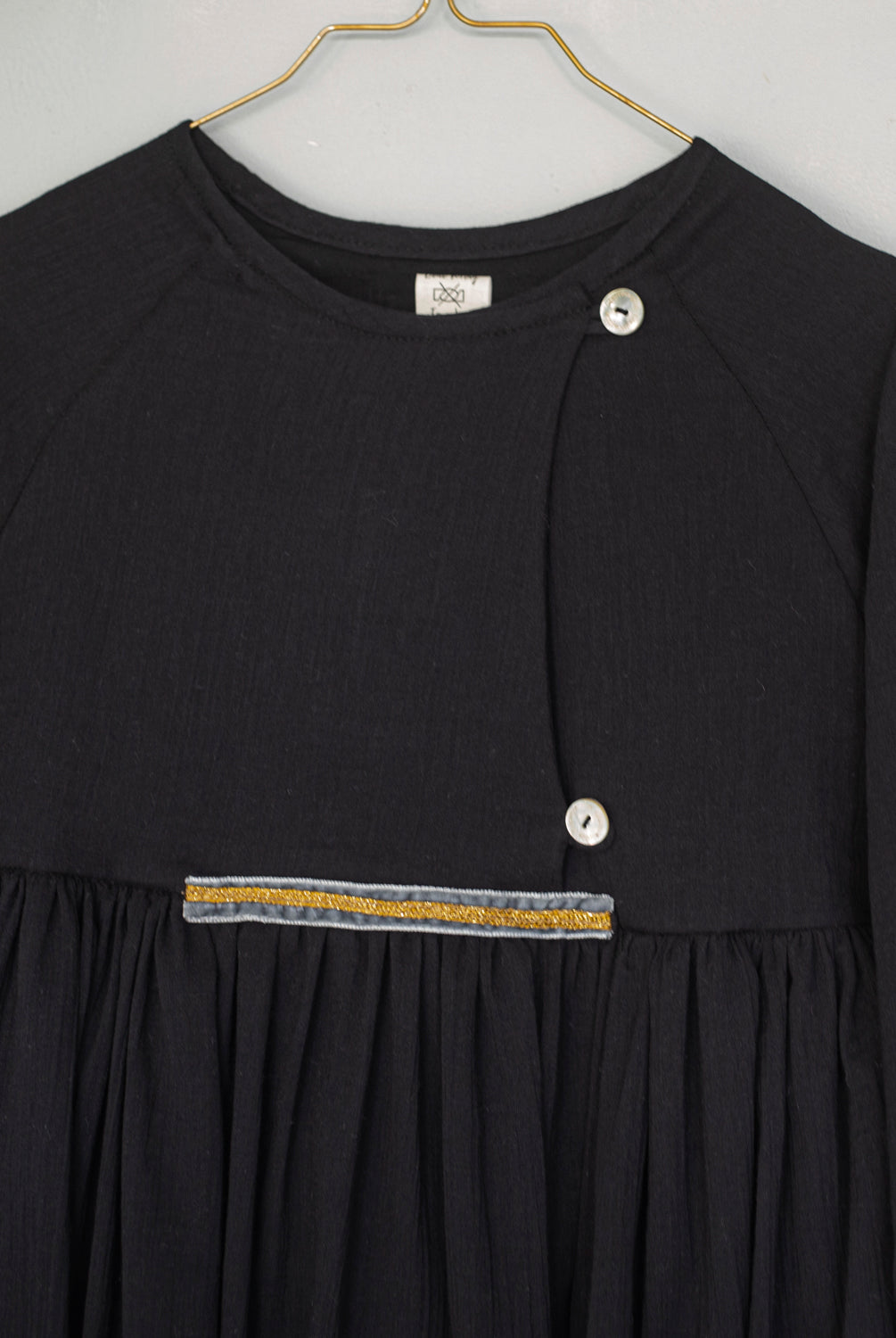 Modest dress in black. Long sleeve. Crossed chest. Velvet and gold detail. European brand dresses