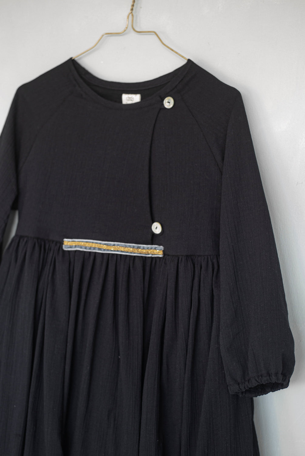 Modest dress in black. Long sleeve. Crossed chest. Velvet and gold detail. European brand dresses