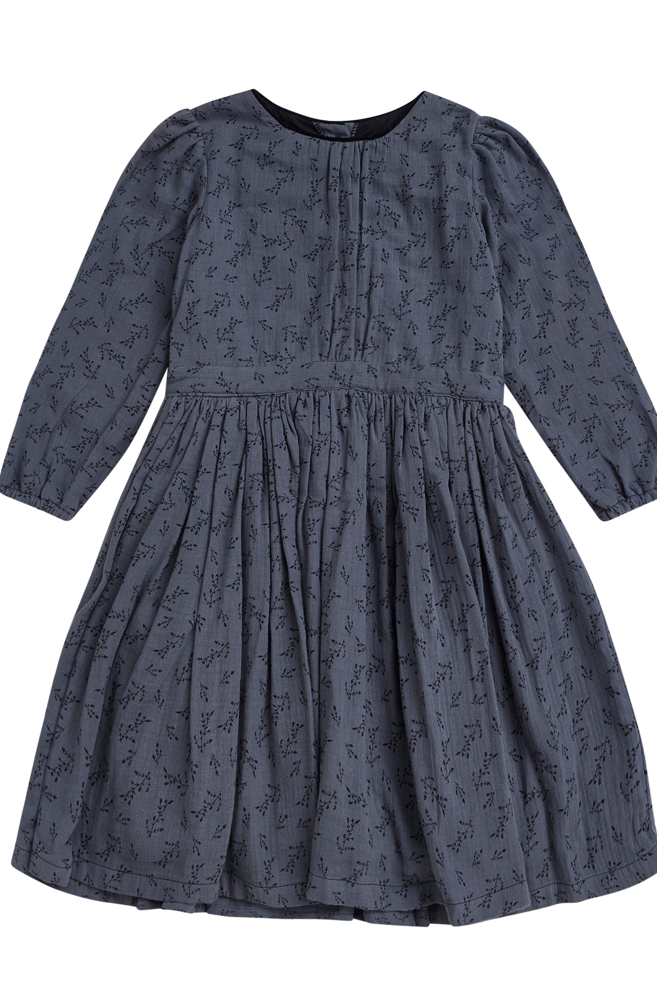 You will love our vintage cut Pandora dress. Contrasting detail on the neck in black. Made in a beautiful double cotton gauze fabric, the print is of small flowers in black on a dark blue background.