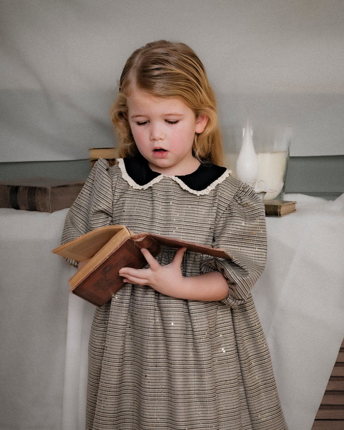 Vestido Tola de niña en cuadro de Gales con lentejuelas, cuello de terciopelo y mangas abullonadas. Diseño romántico y sofisticado.