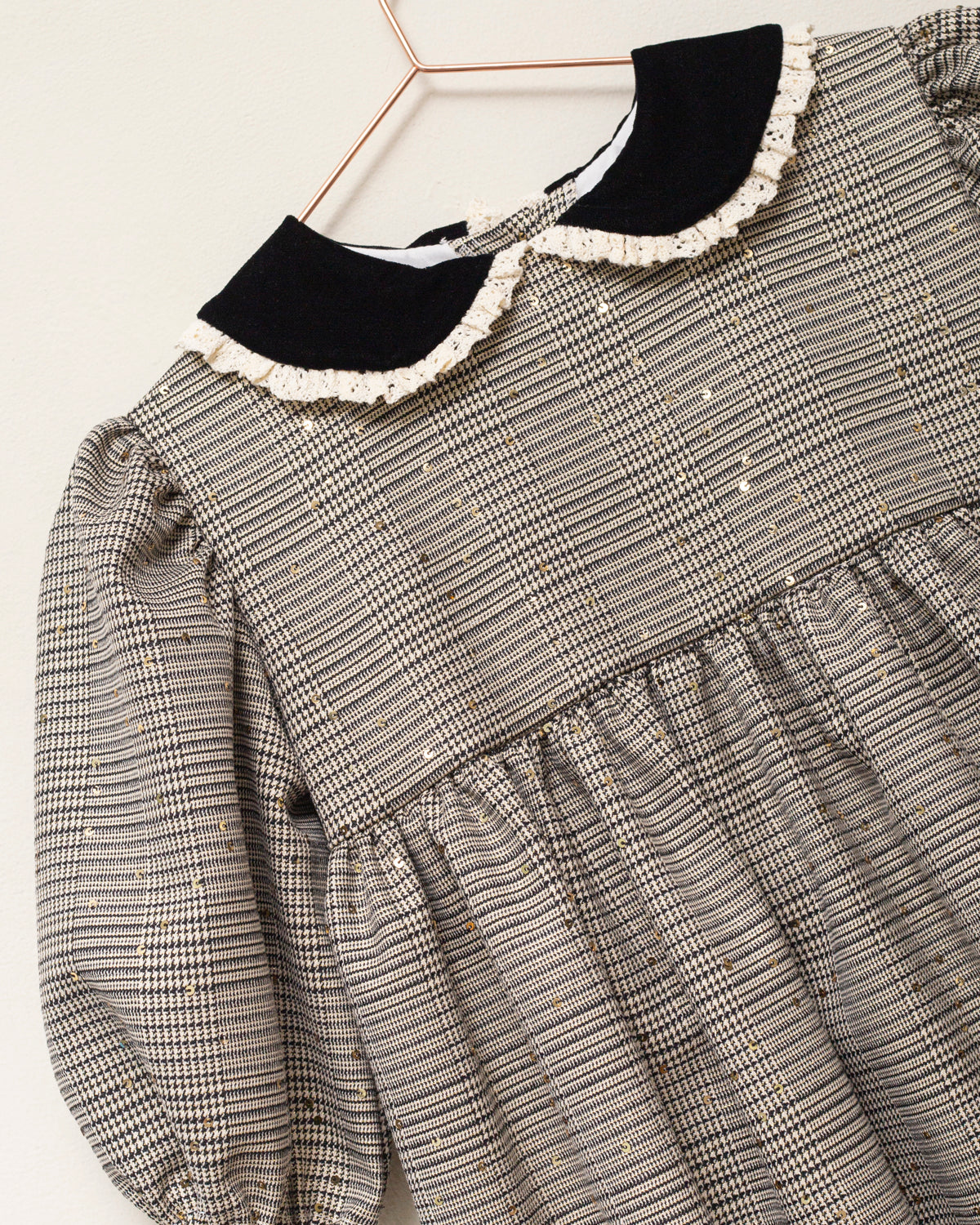 Vestido Tola de niña en cuadro de Gales con lentejuelas, cuello de terciopelo y mangas abullonadas. Diseño romántico y sofisticado.