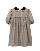 Vestido Tola de niña en cuadro de Gales con lentejuelas, cuello de terciopelo y mangas abullonadas. Diseño romántico y sofisticado.
