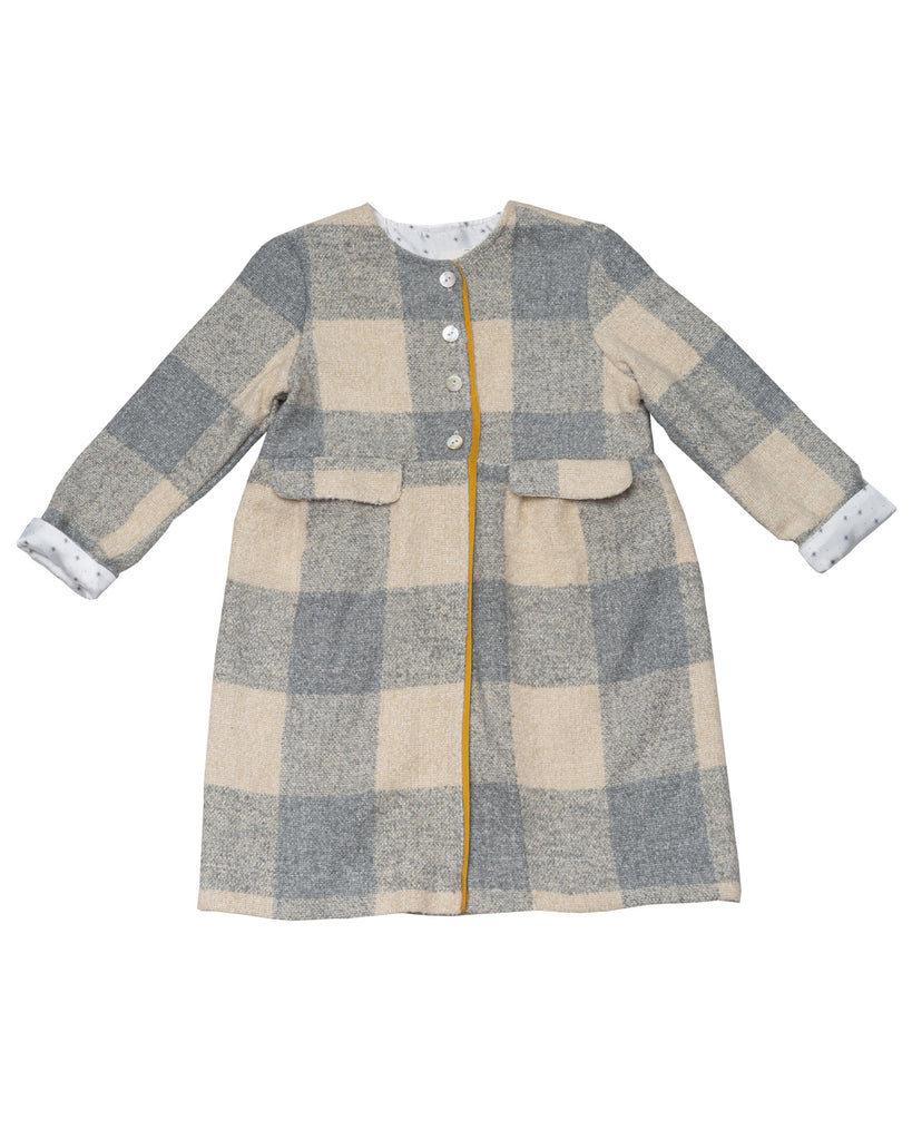 You will fall in love with our wonderful Bimba coat in an oversize gingham check print. Mustard color detail on the front. Lined in a pretty stars print, this coat is just as pretty on the outside as it is on the inside. Ideal to wear on a special occasion or a casual day over jeans.