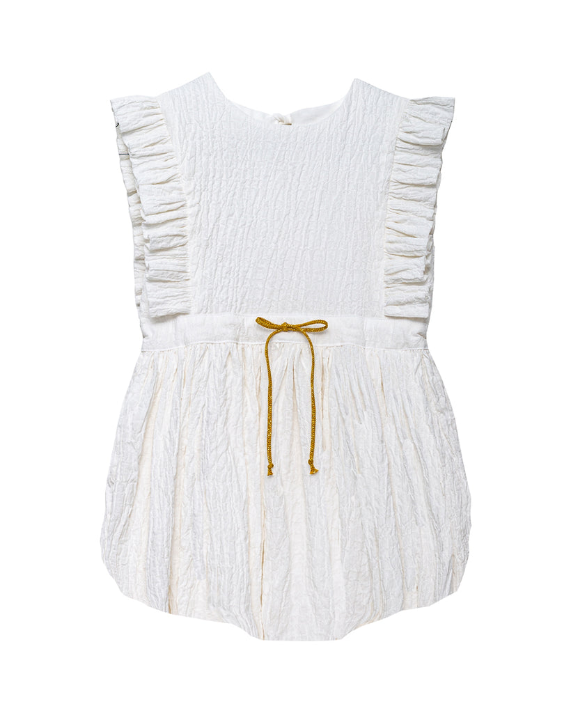 Baby romper in white with ruffled detail and gold bow on waist