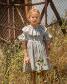 Special occasions dress in light grey. Big peter pan collar. Ruffles on the slevees. Luxury childrens wear eurpean brand