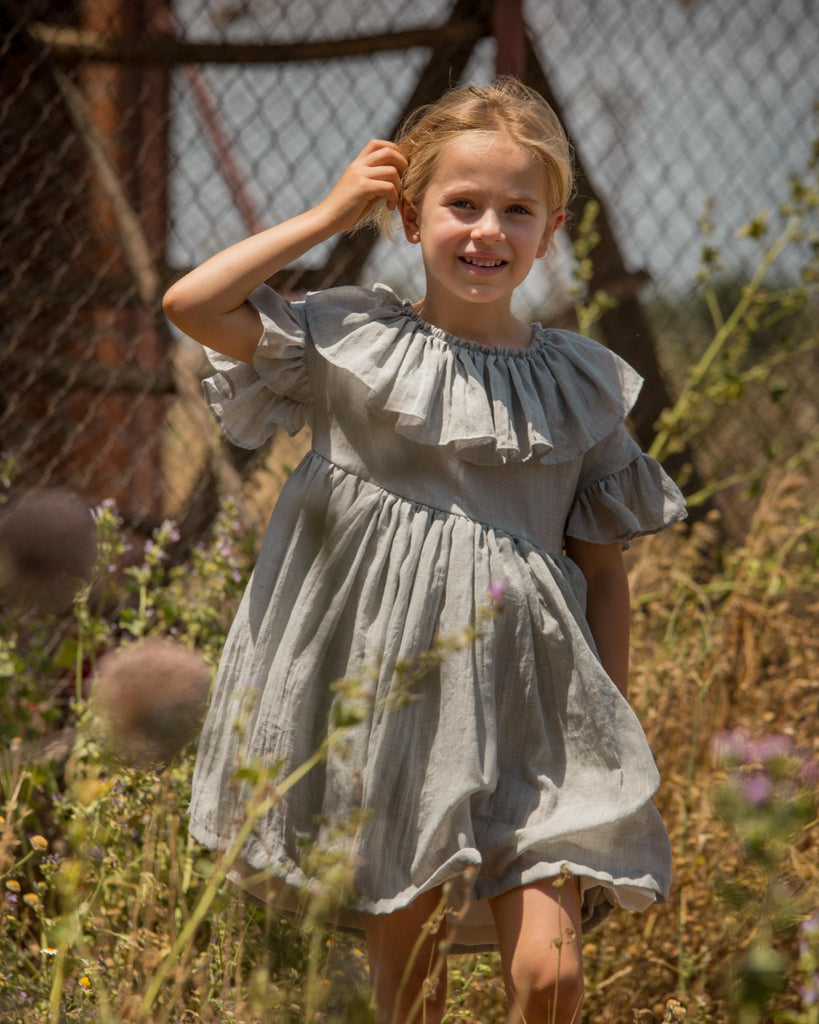 Special occasions dress in light grey. Big peter pan collar. Ruffles on the slevees. Luxury childrens wear eurpean brand