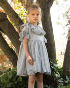 Special occasions dress in light grey. Big peter pan collar. Ruffles on the slevees. Luxury childrens wear eurpean brand