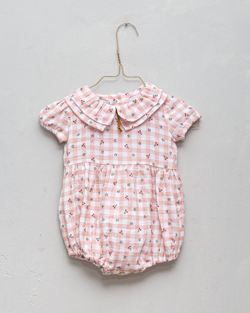 Romper for baby dress in gingham print with flowers. Ruffle neck and gold bow detail. Cosmosophie