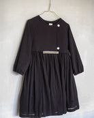 Modest dress in black. Long sleeve. Crossed chest. Velvet and gold detail. European brand dresses