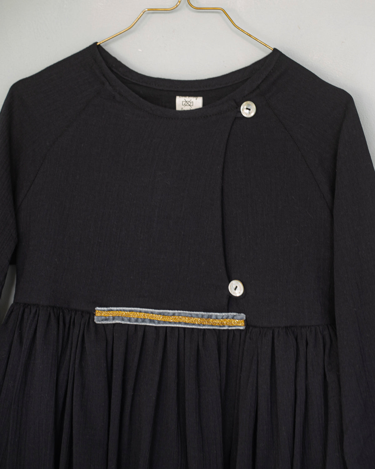 Modest dress in black. Long sleeve. Crossed chest. Velvet and gold detail. European brand dresses