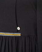 Modest dress in black. Long sleeve. Crossed chest. Velvet and gold detail. European brand dresses