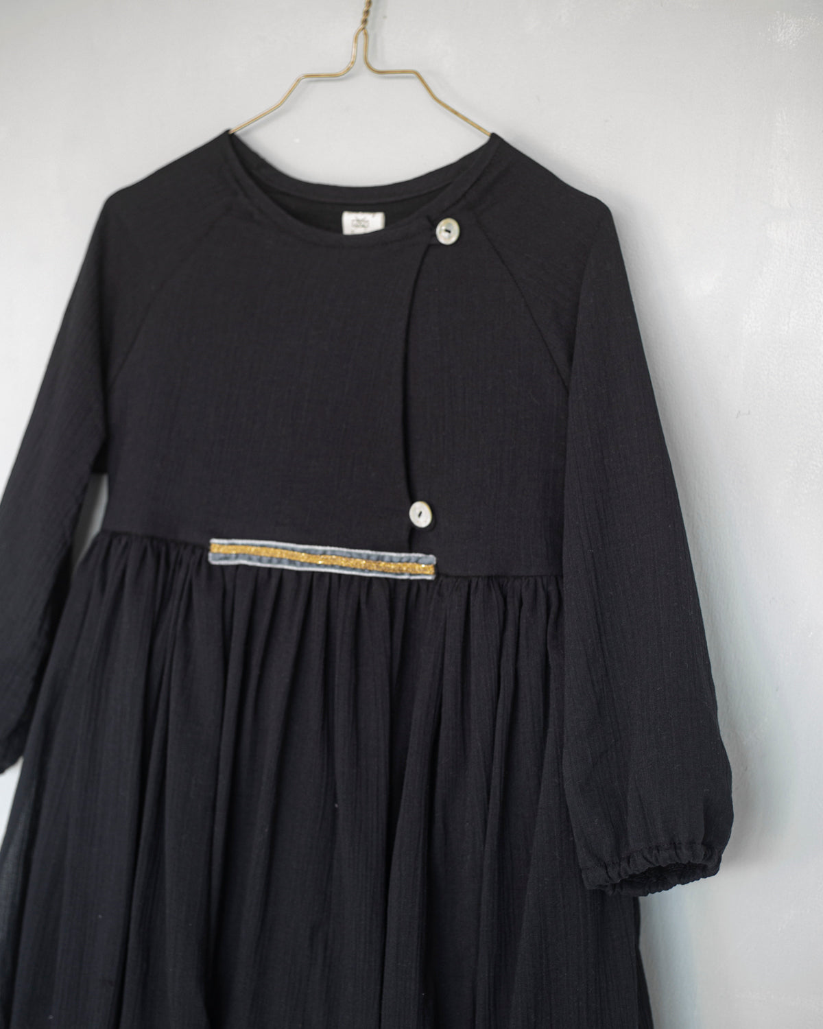 Modest dress in black. Long sleeve. Crossed chest. Velvet and gold detail. European brand dresses