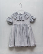 Special occasions dress in light grey. Big peter pan collar. Ruffles on the slevees. Luxury childrens wear eurpean brand